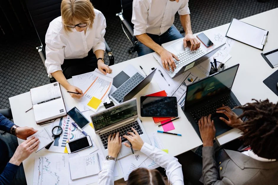 Group of business professionals collaborating in an office setting.